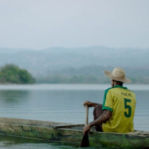 person in Brazil jersey rowing a boat