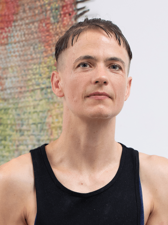 person with short hair wearing tank top