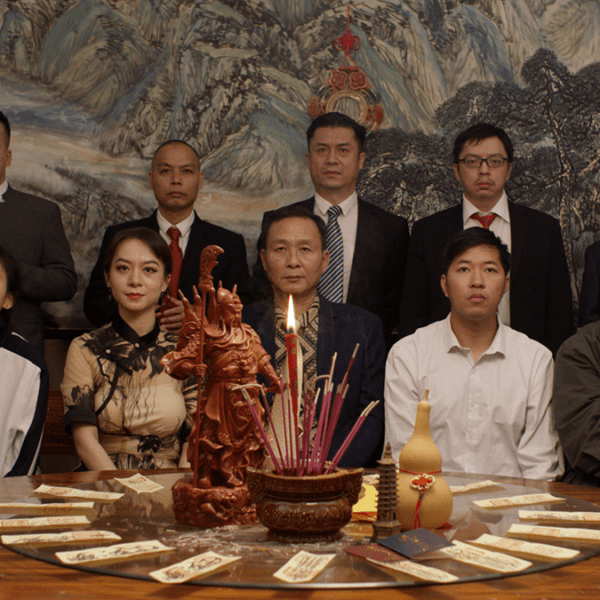 large family sits at a dinner table looking forward