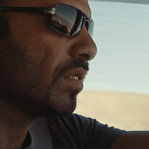 a person drives a car in the desert