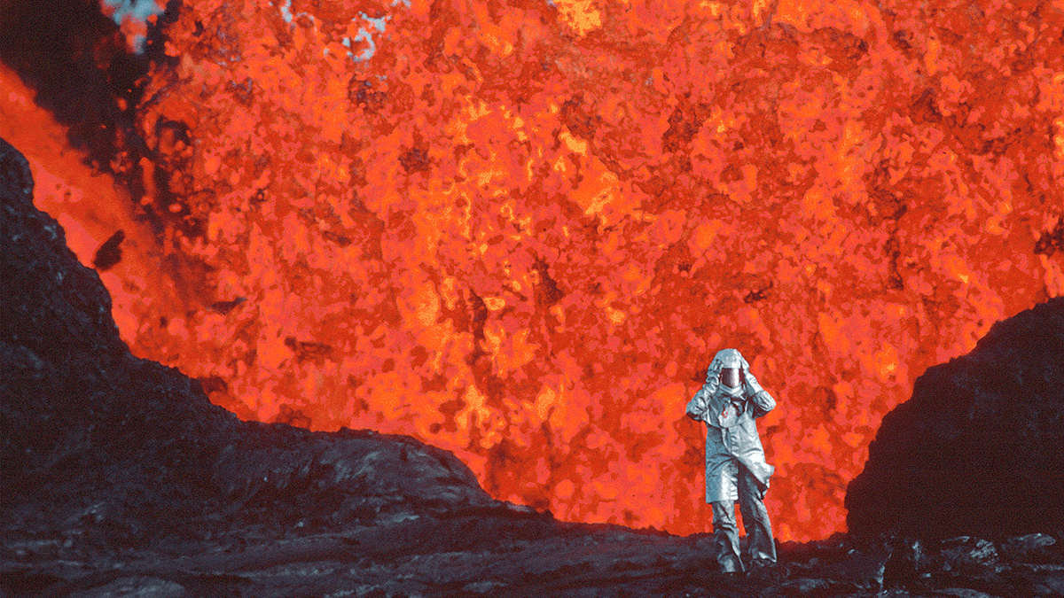 a person in a suit in front of molten lava