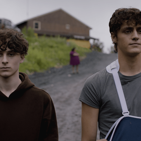 two young adults walk down a countryside road