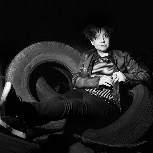 a person laying in a pile of car tires