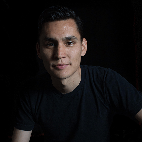 person wearing black t-shirt with black background