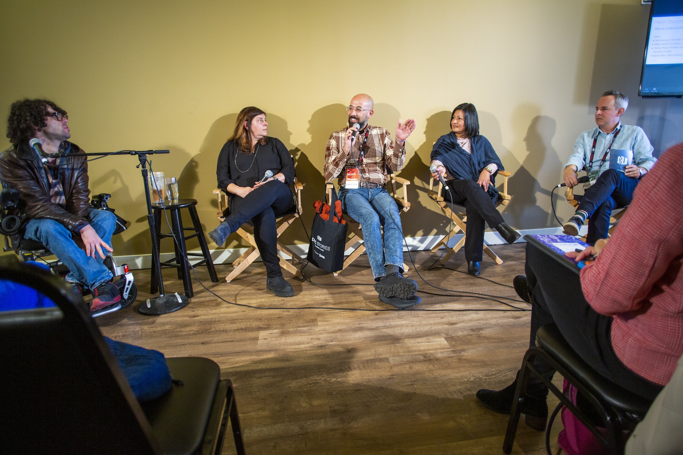 a group of people speaking at a panel.