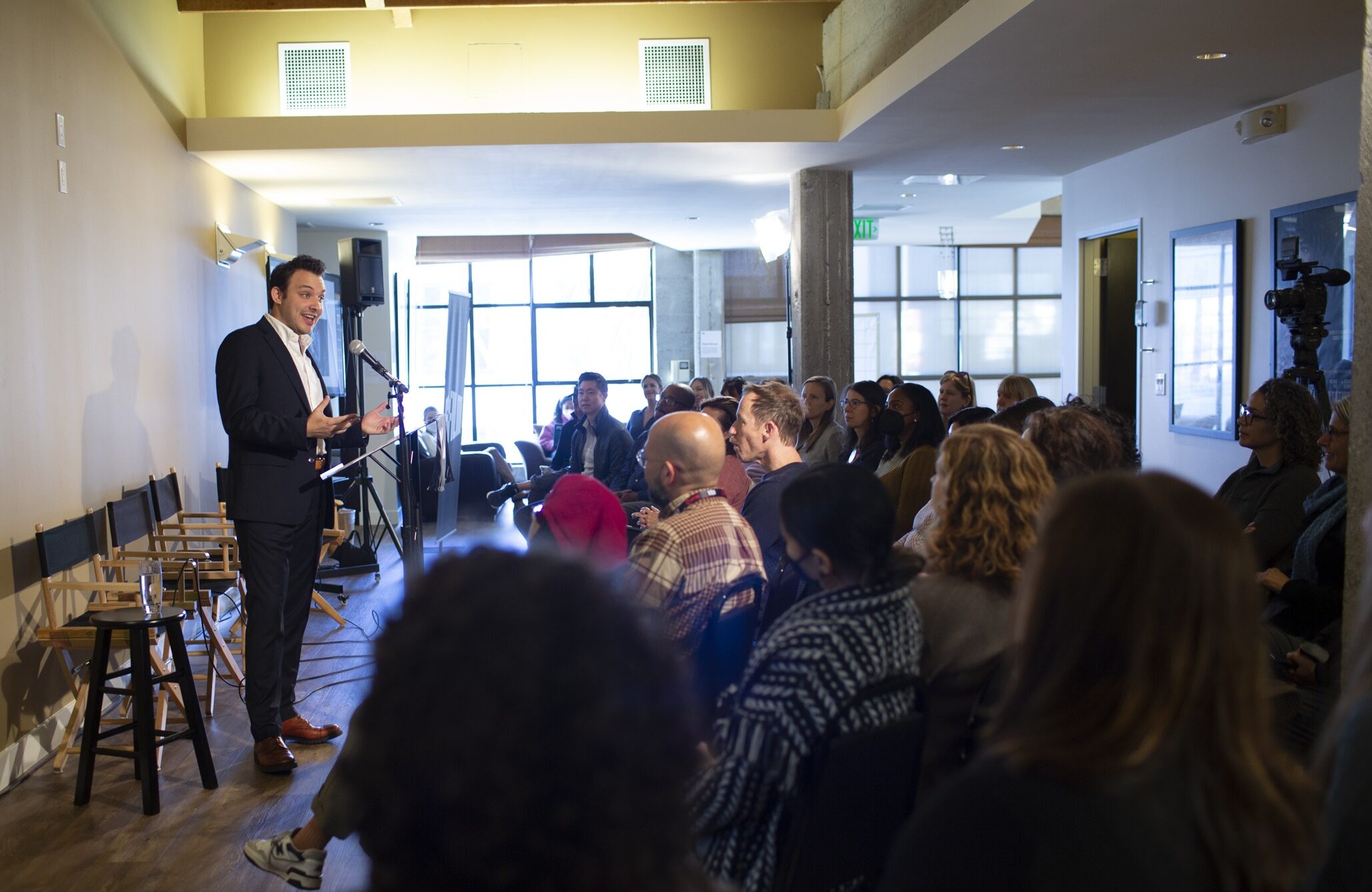 a man speaking in front of an audience.