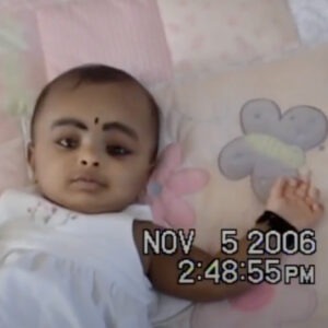 a still of a home video footage of baby laying down.
