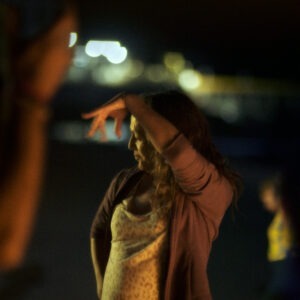 a woman dancing in the night.