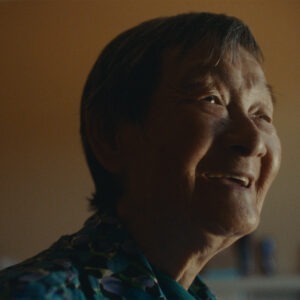 an elderly woman smiling.
