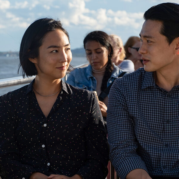 a man and a woman sitting on a boat.