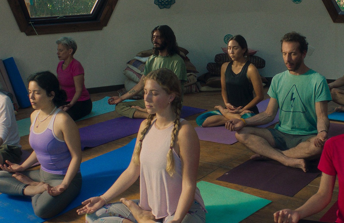 A group of people doing yoga in a room.