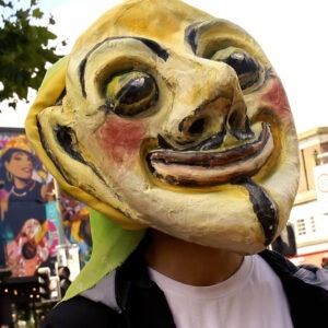 A person wearing a yellow mask on the street.