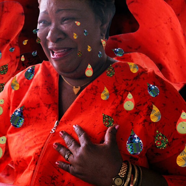 A woman in a red shirt crying colorful tears.