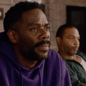 Two men sitting next to each other.