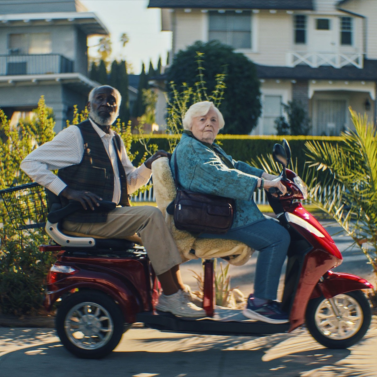 A man and woman on a scooter.