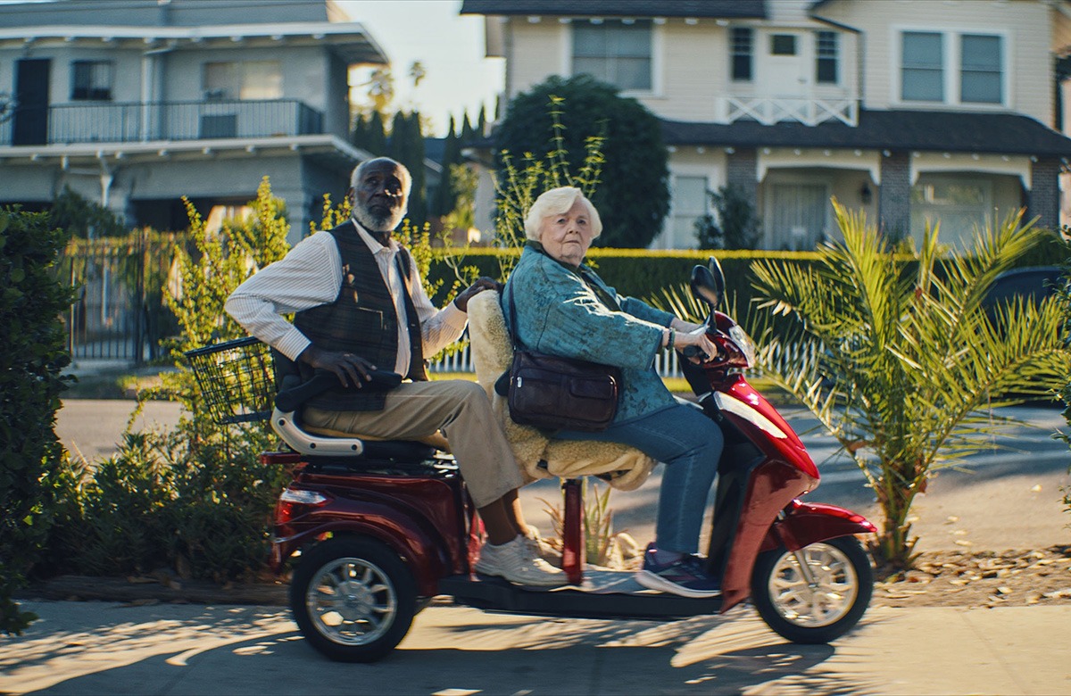 A man and woman on a scooter.