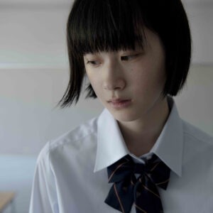 A young girl in a white shirt and tie.